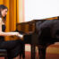Elegant woman playing the grand piano