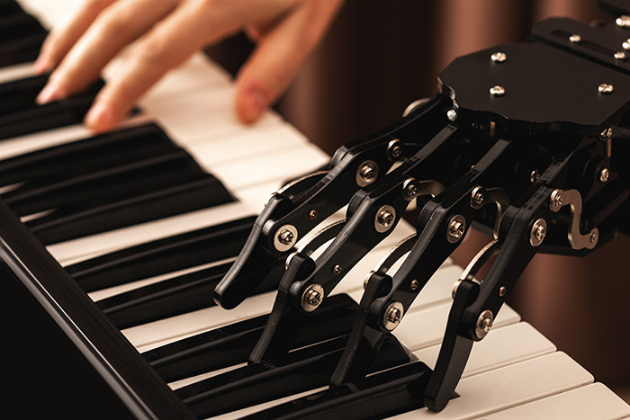 Man hand and robot hand on piano keys