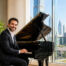 Arabic man sitting at the piano and smiling