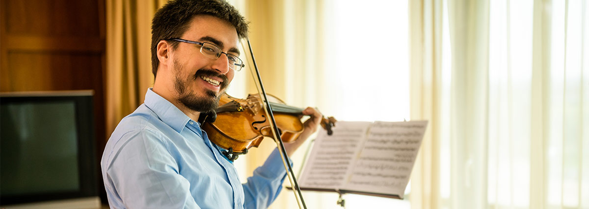 Happy man playing the violin