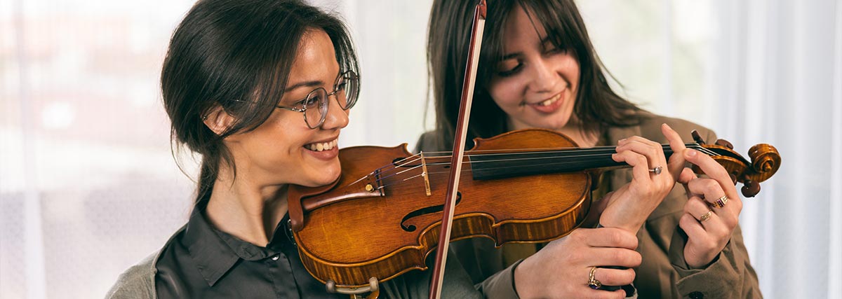 Violin teacher and student having lesson