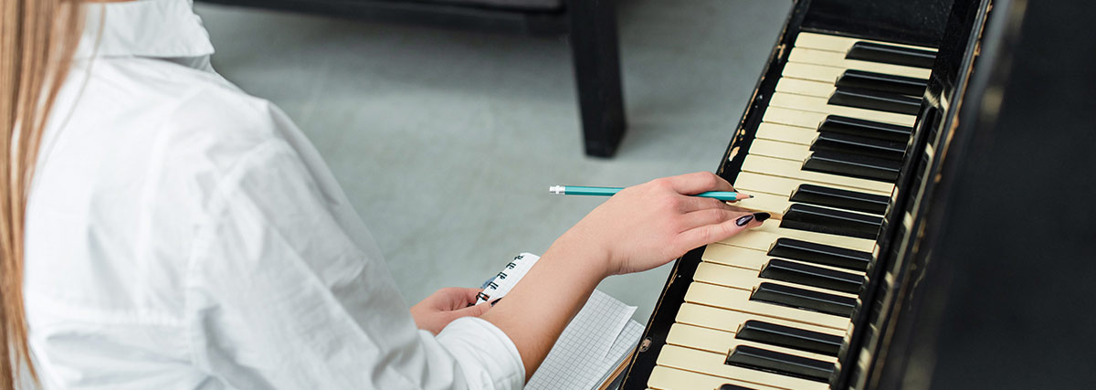 Piano student analysing difficult notes and practising challenging sections of a piano piece