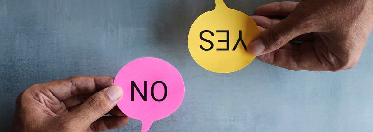 Hands holding yes and no signs