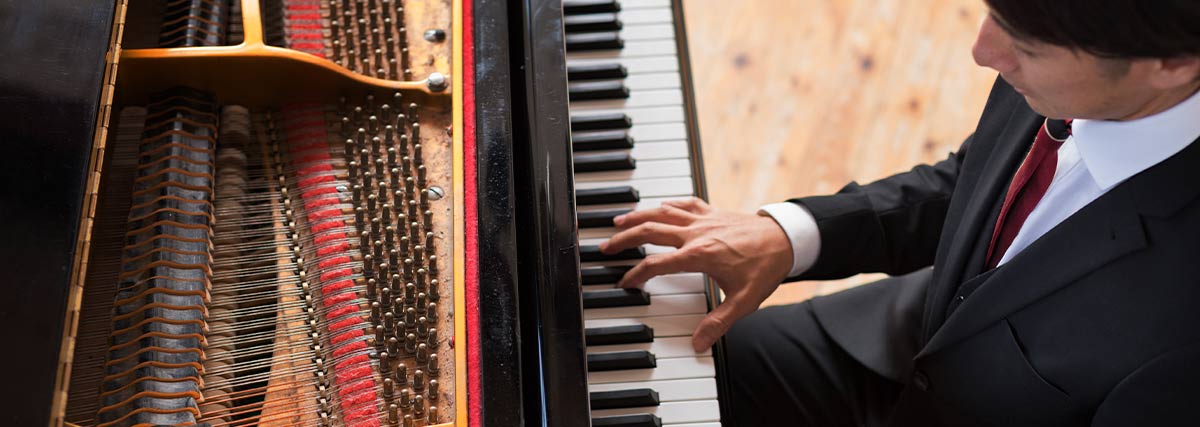 Pianist performing on a grand piano